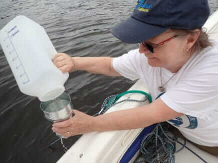 Volunteers testing the water for microplastic content